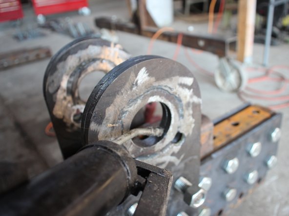 Apply grease to both sides of the round parts of the pivot plates on both sides (4 surfaces) and inside the bushing (hole). Squeeze some out using the gun and then smear it around.