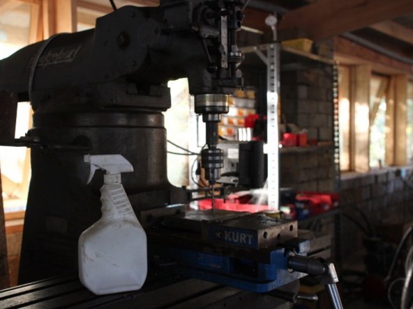 Make holes in the center of each 8"x8" plate big enough for 1" bolts. We drilled starter holes and then used an acetylene torch to widen them.