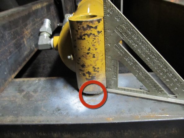 Add a 1/8" spacer (big washers work great) under the cylinder, where it contacts the lower crossmember. This insures the cylinder is centered vertically. Where to put it is circled in the first image.
