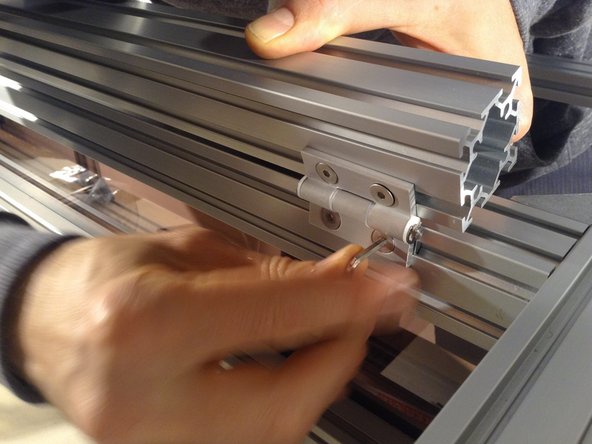 Mount the 4040 extrusion top door frame, and it should be 2.8 cm off edge on each side.