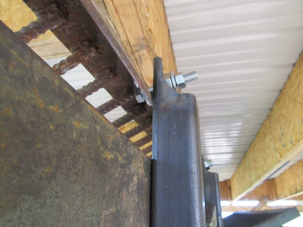 Get a friend or two and lift the grate on top of the hopper.