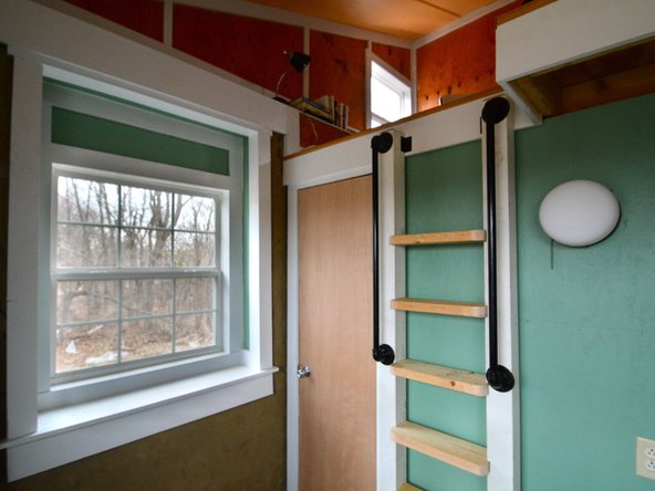 Mount the ladder to the MicroHouse wall using the 4 L-brackets, two on the top and two on the bottom.