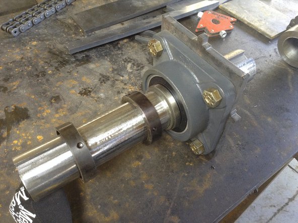 Feed shaft through bearings and lock colars