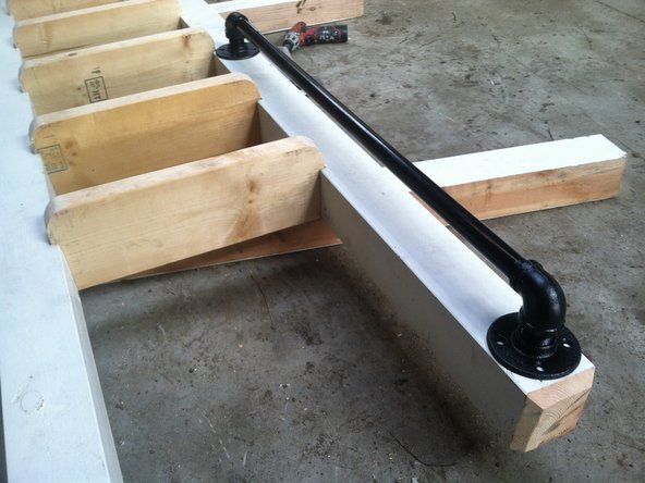 Lay out one of the handrails so that the flange comes to rest just below the bevel. The other end with land right next to step.