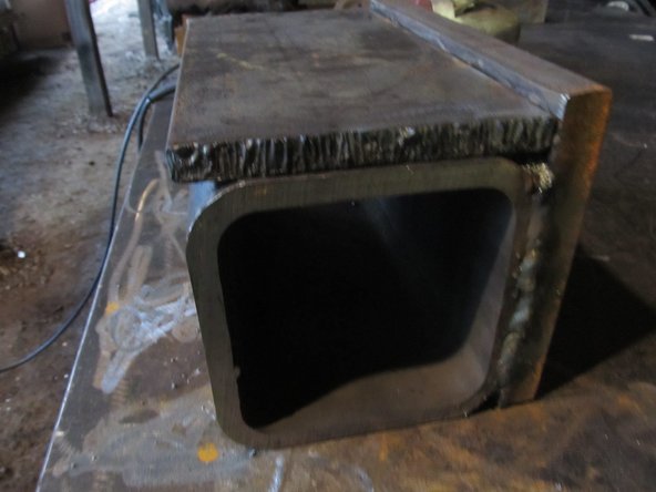 Weld the vertical support to the press plate and spacer tube assembly.