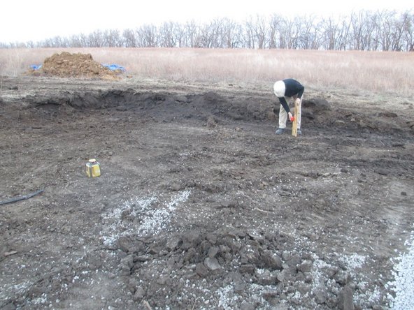 You can strip off the topsoil, as well, or otherwise change the grade at this point. In our case, we had little topsoil and we liked the way the grade worked out by raising the building up on the gravel.