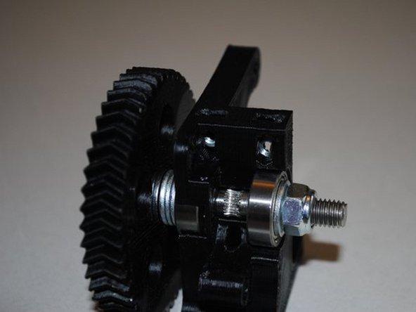 Install 2x M4 nuts into the top of the extruder body as shown.