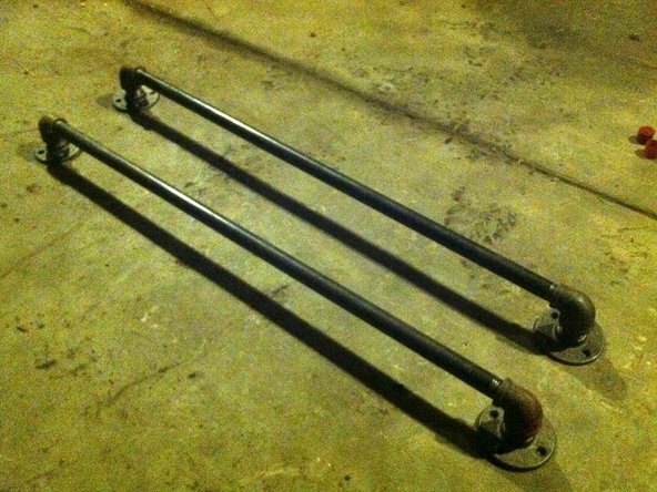 Add the end brackets to the two pieces of 3' long 1/2" pipe. The finished rails look like photo 3.