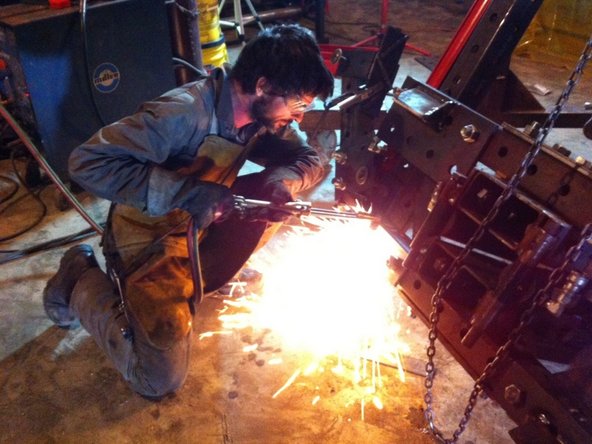 Determine the location of the latch hole for the bottom quick attach part and torch it out