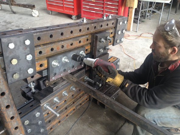Tighten the upper blade holder plate bolts down so that the metal is firm against one another but still able to move. Do this on the side of the ironworker opposite of the table