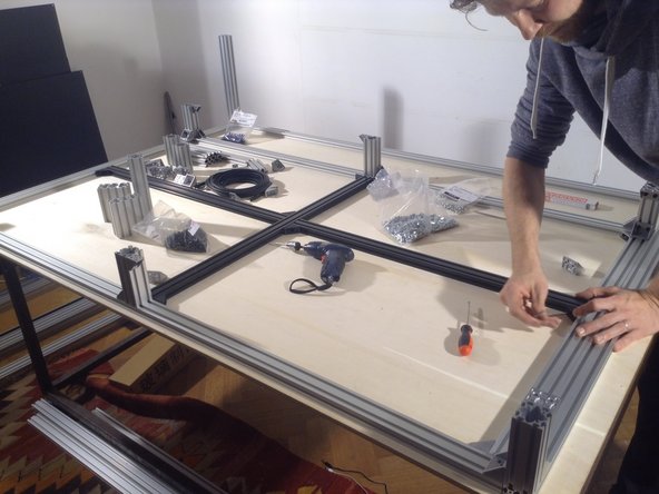 Install middle black supports on the floor of the frame, using single black brackets, 1 per meeting point