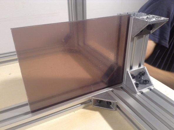 Peel the protective covering from the small panel, and insert.