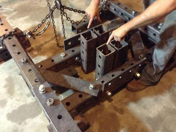 Attach Main Pivot Tubes to Quick Attach tubes. Leave a space of 4" between them. Use ~10" bolts to attach Reinforcement plates to the Main Pivot Tubes (through Quick Attach tubes)