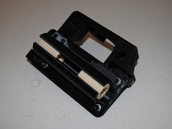 Assemble the double bearing holder onto the X motor mount with 4x M3 x 12 SHCS and washers.