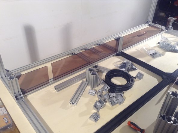 Peel the protective covering from the long panel, and insert.