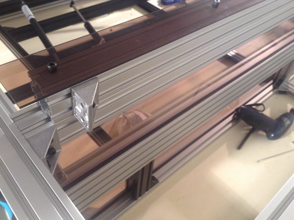 Mount 3 door mounts to the 4040 hinged extrusion. Use double brackets on the ends and a single bracket in the middle.