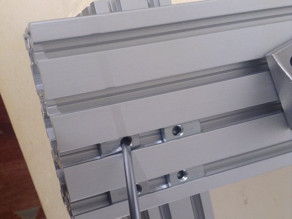 Put in 4 spring nuts. Note that these may be inserted from the top of the rail, not necessarily from the side. Use 4 of these per corner bracket.