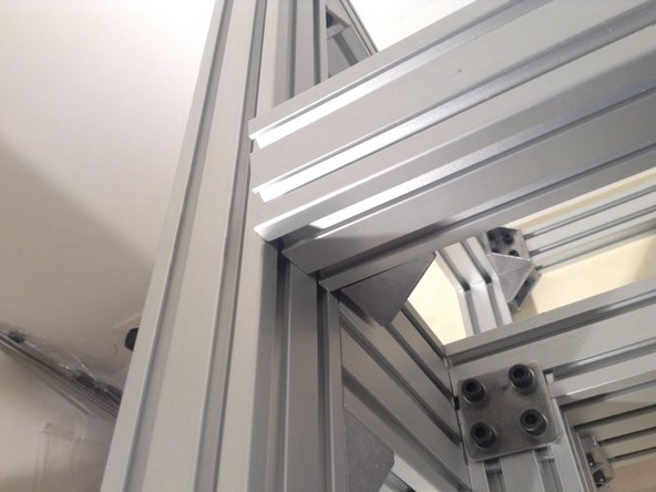 Mount 4040 extrusion for the rear of the cutting chamber - using 2 double brackets at the sides and a double planar bracket in the middle.