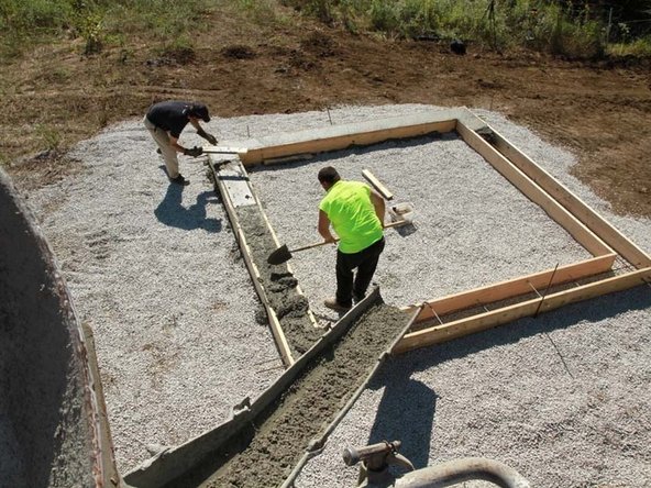 Pour concrete into foundation forms. Fill the foundation forms with concrete and smooth off the top with a screed board. We had a truck deliver the concrete, but you could also mix it yourself in a concrete mixer or in a wheelbarrow with a mixing hoe.