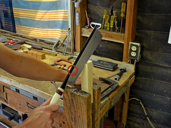 Begin your cut by placing the bottom edge of the saw on the corner edge of the workpiece. Make sure the saw blade lines up with any markings you made on the workpiece for this cut.
