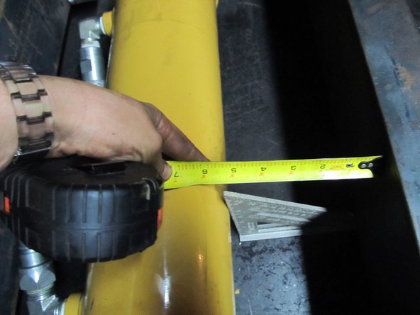Make sure the cylinder is centered, using a speed square pressed against the side of the cylinder, and a tape measure to the to the vertical members as shown.