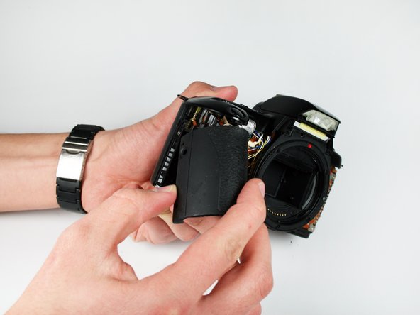 Disassembling Canon EOS Rebel XS Battery Door: step 9, image 1 of 1