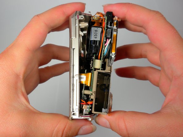 Olympus Stylus 410 Battery Cover Replacement: step 11, image 1 of 2