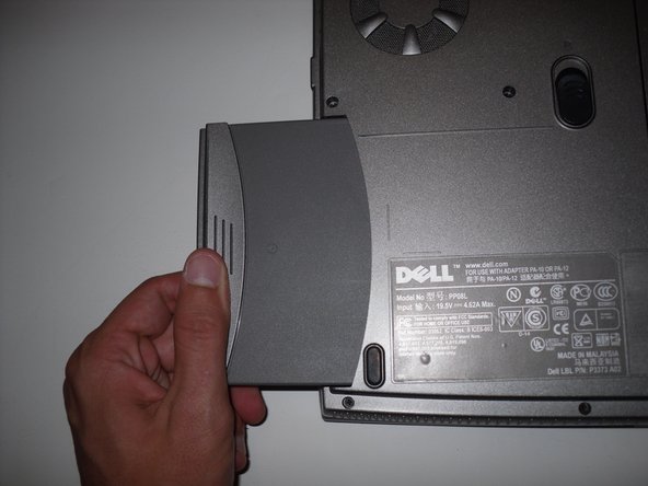 Removing the Dell Inspiron 1150 Modem Card, Removing the Dell Inspiron 1150 Modem Card: step 1, image 3 of 3