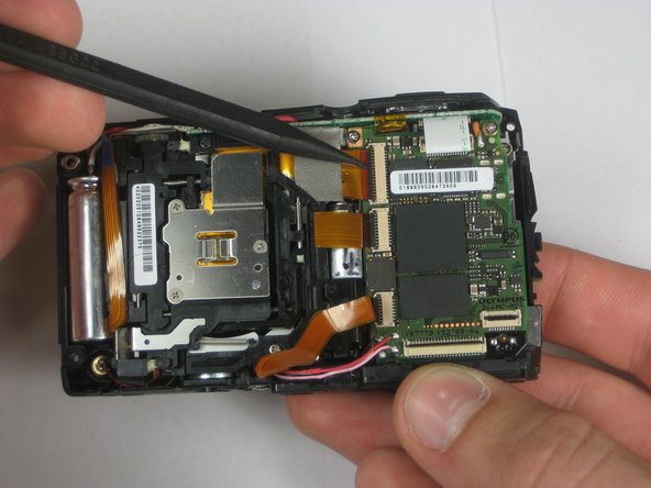 Disassembling Olympus Stylus 1010 Logic Board: step 8, image 1 of 2