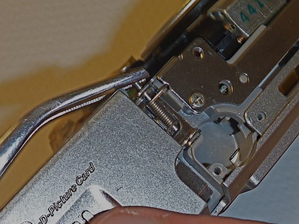 Olympus D590 Retainer Clip Replacement: step 10, image 1 of 1