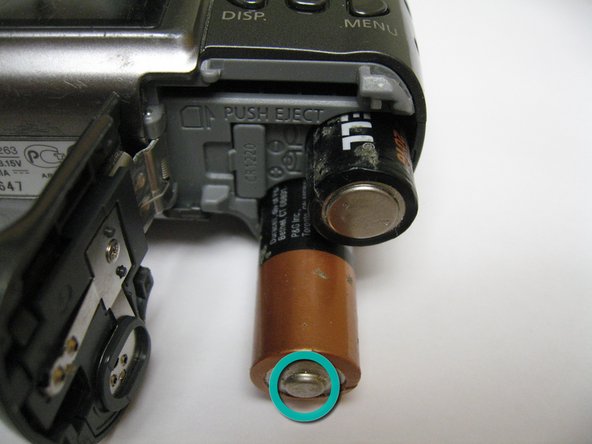 Disassembling Canon PowerShot A590 IS Front Cover, Replacing Camera Batteries: step 3, image 1 of 1