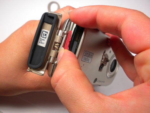 Olympus Stylus 410 Battery Cover Replacement: step 8, image 1 of 2