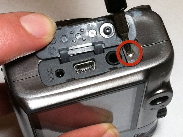Disassembling Canon PowerShot A590 IS Front Cover, Remove Screw Near AV Port: step 4, image 1 of 1