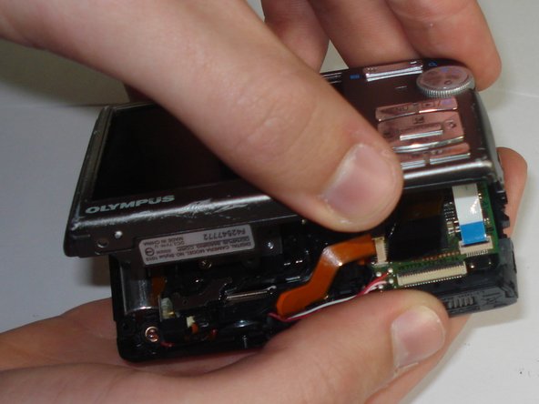 Disassembling Olympus Stylus 1010 Logic Board: step 7, image 2 of 3