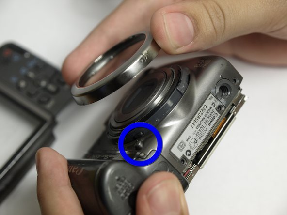 Disassembling Canon PowerShot A590 IS Front Cover, Remove Lens Cover: step 8, image 1 of 1