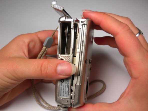 Olympus Stylus 410 Battery Cover Replacement: step 9, image 2 of 3