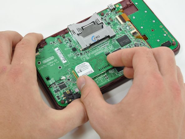 Nintendo DSi XL Camera Ribbon Replacement: step 8, image 1 of 2