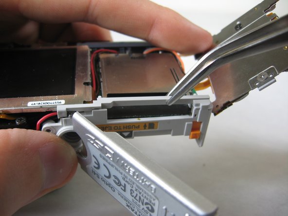 Disassembling Pentax Optio S4i Lens Assembly: step 11, image 2 of 3